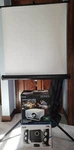 Black Series Movie Projector, Cyber Acoustics Speaker Set, & Tripod Screen. Fixed Price $125.00.